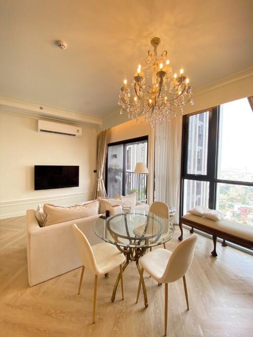 Modern living room with chandelier and city view