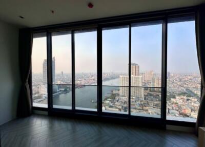 Spacious living room with floor-to-ceiling windows and city view