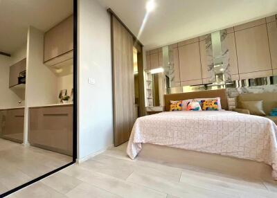 Modern bedroom with an adjacent kitchenette