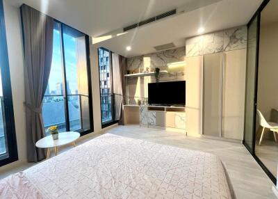 Modern bedroom with large windows and a city view