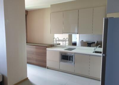 Modern kitchen with integrated appliances and neutral decor