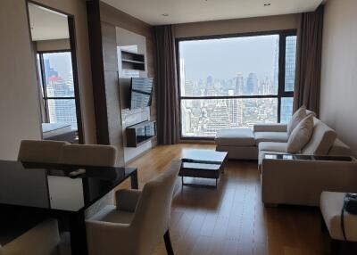 Spacious living room with large windows and city view