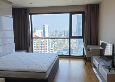 Spacious bedroom with a city view