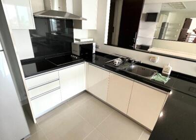 Modern kitchen with white cabinets and black countertops