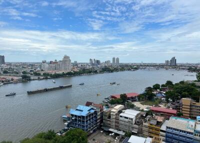 High-rise buildings near a river with boats