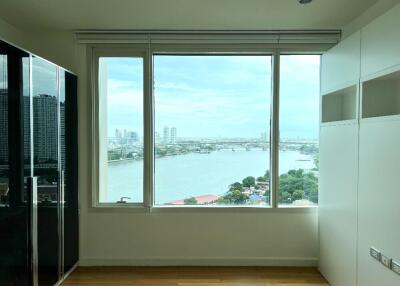 room with large window and city river view