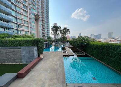 Outdoor swimming pool view with adjacent high-rise building