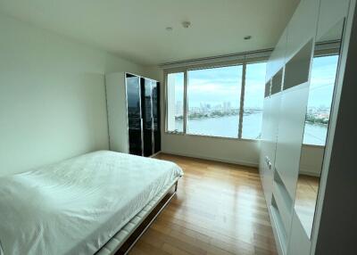 Bright bedroom with large windows and a city view