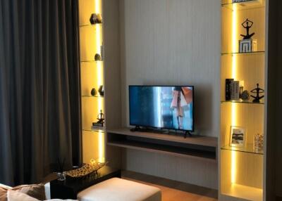 Modern living room with illuminated shelving and TV