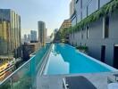 Rooftop pool area with a view of city buildings