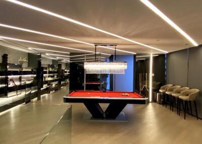 Modern recreation room with a pool table and bar seating