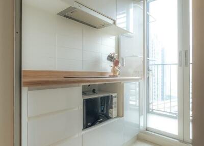 Modern kitchen with white cabinets and wooden countertop