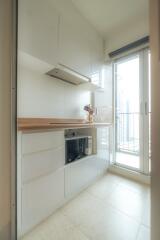 Modern kitchen with white cabinets and wooden countertop