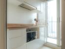 Modern kitchen with white cabinets and wooden countertop