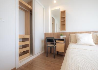 Modern bedroom with built-in wardrobe and workspace