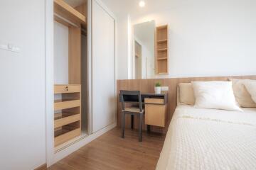 Modern bedroom with built-in wardrobe and workspace