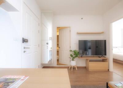 Bright and cozy living room with modern furniture and a large TV