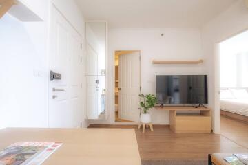 Bright and cozy living room with modern furniture and a large TV