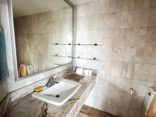 Spacious bathroom with large mirror and sink