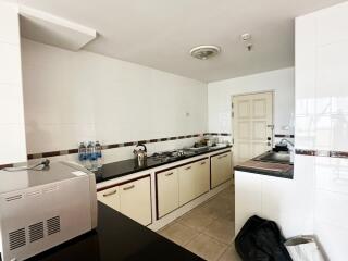 Modern kitchen with long countertop and white cabinets