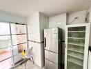 Modern kitchen with stainless steel refrigerator and glass cabinet