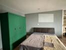 Bedroom with bed, green wardrobe, and modern design