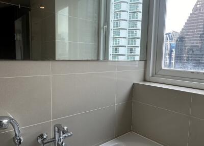 Modern bathroom with a bathtub and large window