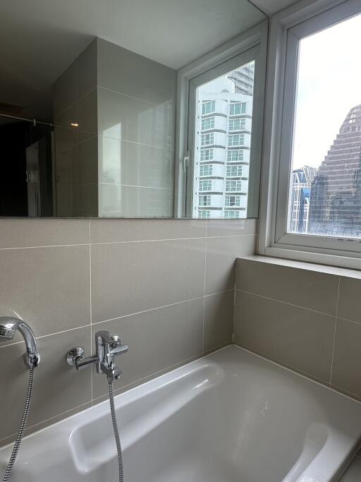 Modern bathroom with a bathtub and large window