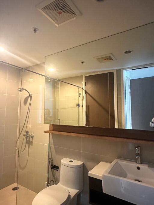 Modern bathroom with glass shower enclosure and vanity