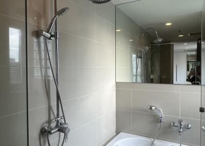 Modern bathroom with bathtub and overhead shower