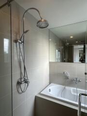 Modern bathroom with bathtub and overhead shower