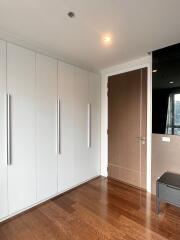 Modern bedroom with hardwood floors and built-in wardrobe