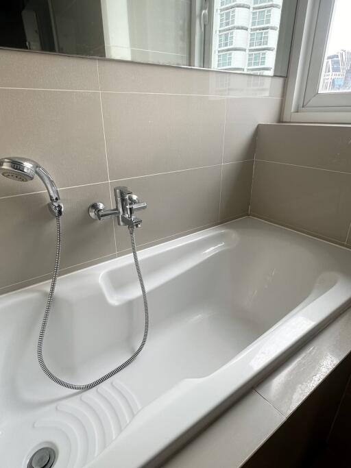 Modern bathroom with bathtub and showerhead