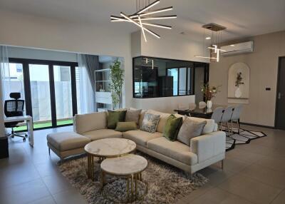 Modern living room with sofa, coffee tables, and decorative lighting