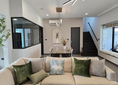 Modern living room with staircase and dining area