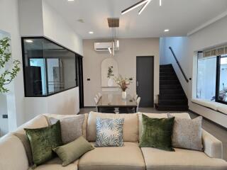 Modern living room with staircase and dining area