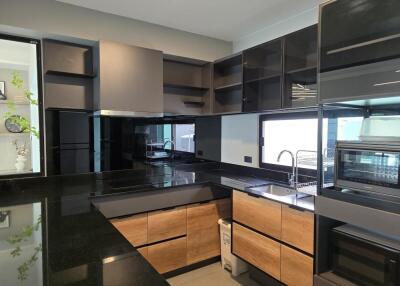 Modern kitchen with black and wood cabinets