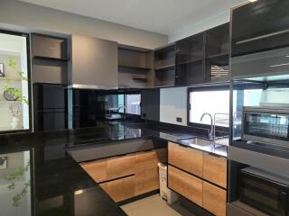 Modern kitchen with black and wood cabinets