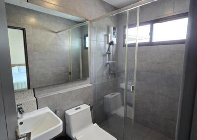 Modern bathroom with glass shower and large mirror