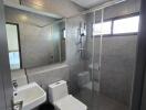 Modern bathroom with glass shower and large mirror