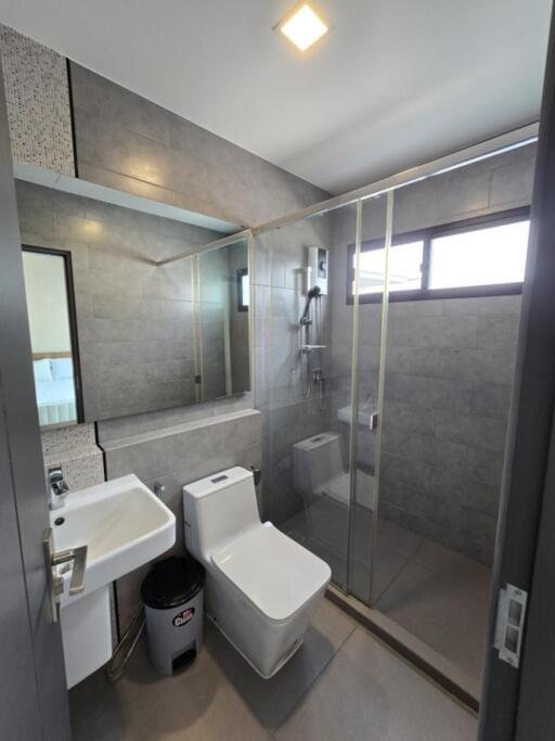 Modern bathroom with glass shower and large mirror