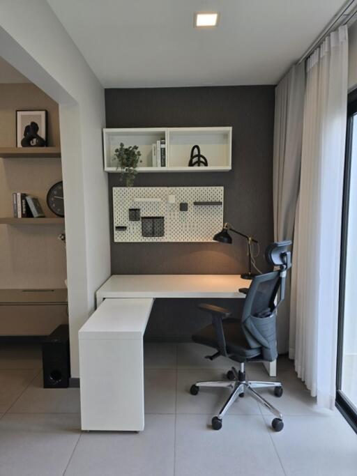 Modern home office with desk, chair, and shelving