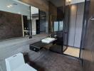 Modern bathroom with dark tiles, glass shower, and floating vanity