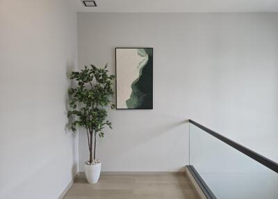 Hallway with plant and wall art