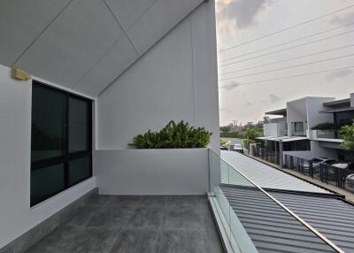 Spacious balcony with modern design and glass railing