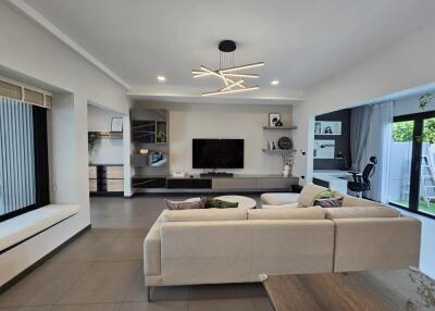 Modern living room with sofa, TV, and decorative lighting