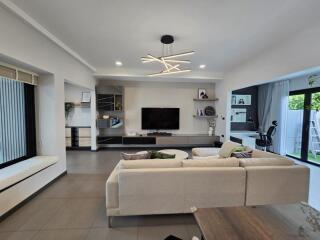 Modern living room with sofa, TV, and decorative lighting