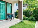 Outdoor patio with chairs and greenery