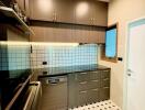 Modern kitchen with dark cabinets and tiled backsplash