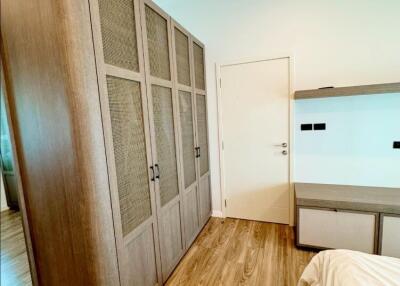 Bedroom with large wardrobe and wooden floor